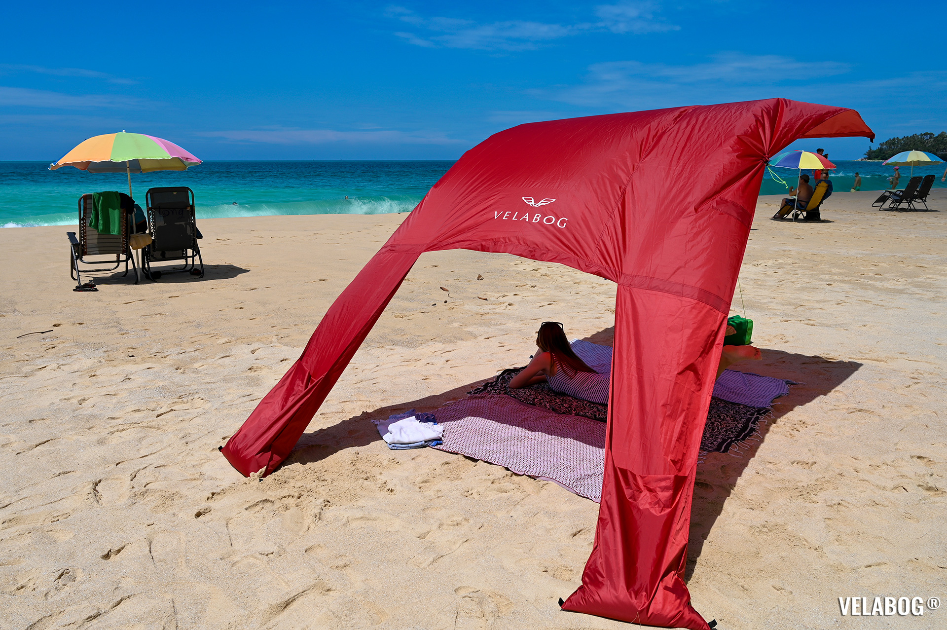 Beach sun sail Velabog Breeze, red. Best beach canopy tent, a lot more shadow compared to beach umbrellas. Setup option for light to strong wind. Generous shadow.