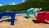 Three beach sun sails Velabog Breeze on the beach show different setup options. Beach sun sail, beach umbrella and beach tent in one. Whether without wind or with any type of wind, you have always the best sun shelter on the beach. Best beach canopy.