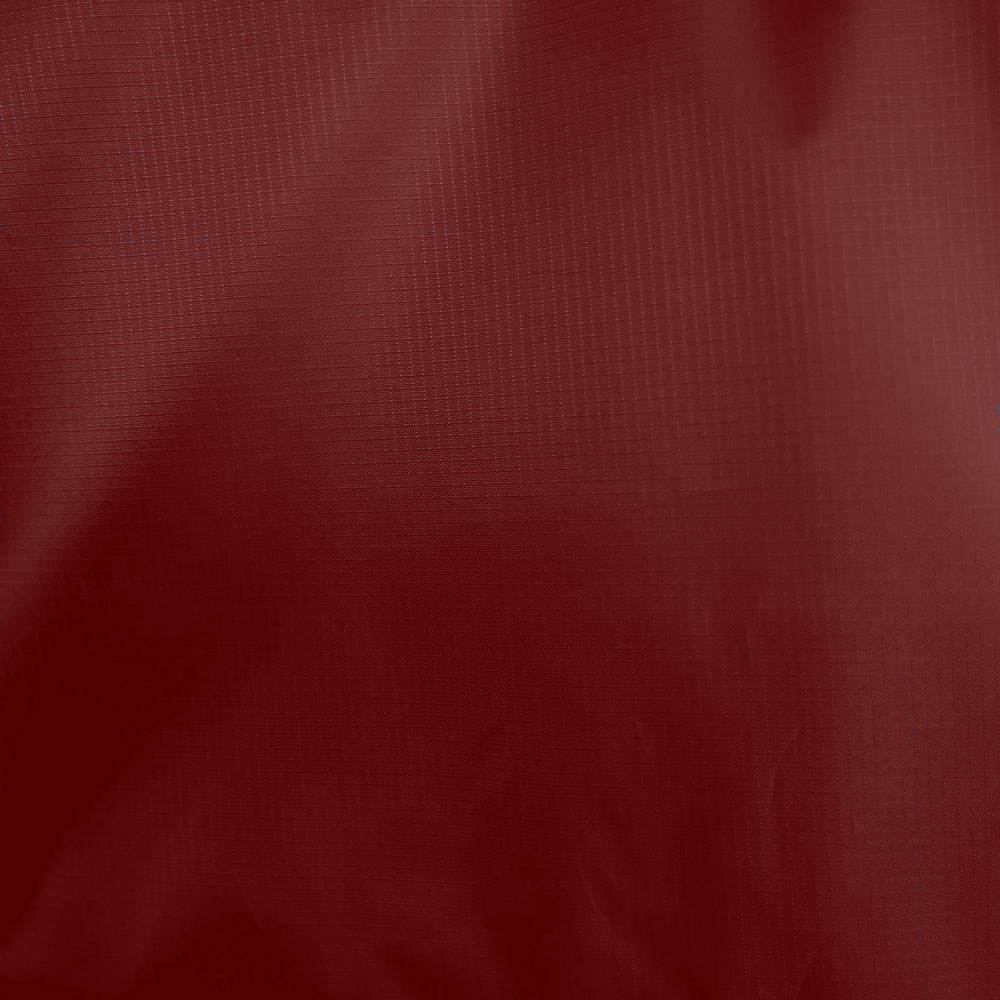 Detail of the fabric surface of the beach sun sail shelter Velabog Breeze. 100% ripstop polyester. Color red.