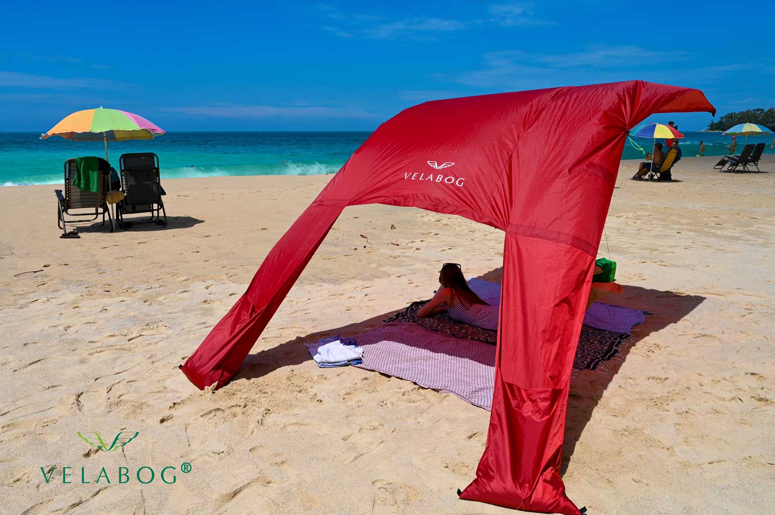Velabog «Breeze» żagiel słoneczny - czerwony. Dużo większy odcień w porównaniu z parasolami plażowymi. Może być używany przy lekkim lub silnym wietrze. Hojny cień.